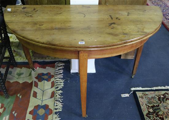 A French fruitwood demi lune fold out dining table, 124cm.